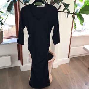 3/4 sleeve, U neck fitted dress with ruched sides.